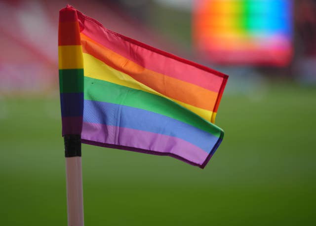 A rainbow corner flag at the side of the pitch (John Walton/PA)