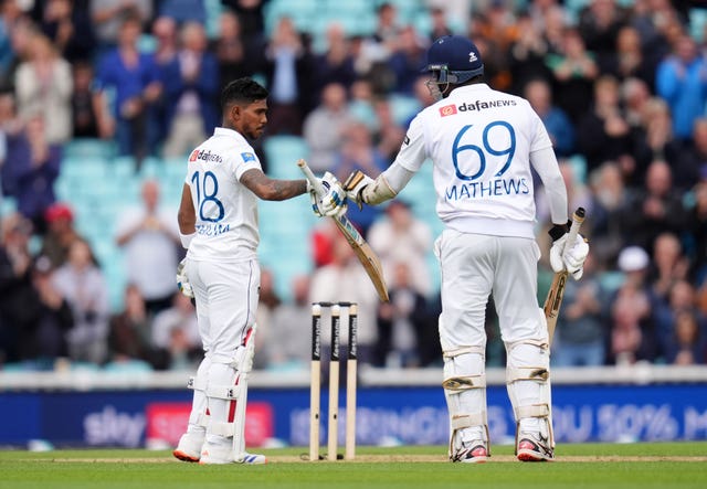 Sri Lanka’s Pathum Nissanka celebrates reaching his century as he bumps gloves with Angelo Mathews