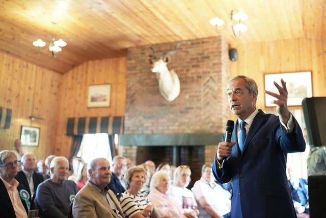 Reform UK leader Nigel Farage speaking to people seated during a visit to Catton Hall in Frodsham, Cheshire
