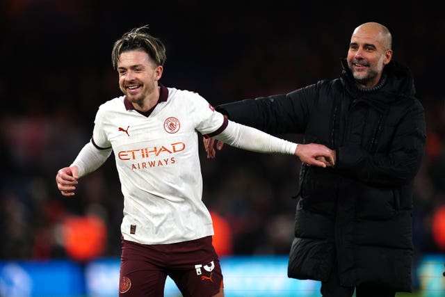 Jack Grealish, left, and Pep Guardiola celebrate Manchester City's win over Luton