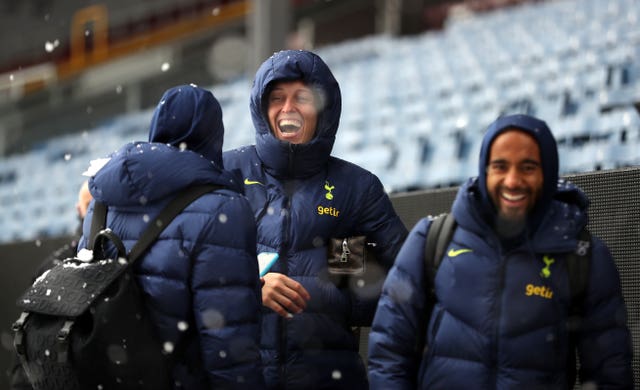 Tottenham players Emerson Royal, left, and Pierluigi Gollini play with the snow as their match at Turf Moor is postponed