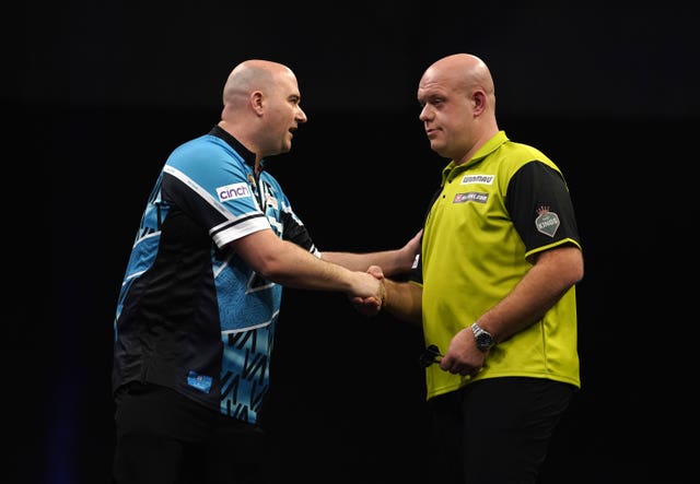 Rob Cross (left) celebrates victory against Michael van Gerwen during night four of the Premier League in Exeter