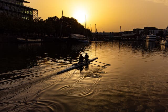 Rowers make ripples across Bristol Harbourside as the sun rises over the city on Wednesday