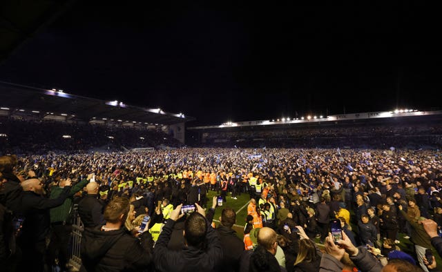 A Barnsley player was attacked after Portsmouth fans invaded the pitch in celebration of their side's promotion to the Championship 