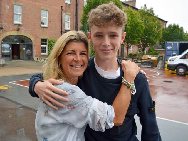 Finn Elliot, star of The Crown TV series, hugs his mother Mini at Portsmouth Grammar School