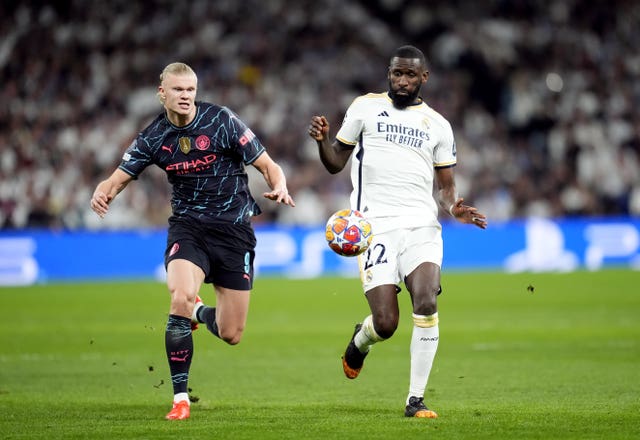 Manchester City’s Erling Haaland and Real Madrid’s Antonio Rudiger, right, battle for the ball
