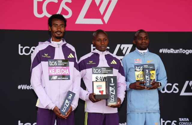 Sabastian Sawe, centre, Yomif Kejelcha, left, and Jacob Kiplimo, right, on the London Marathon podium