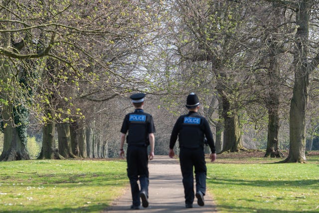 Police officers patrol a park in Northampton 