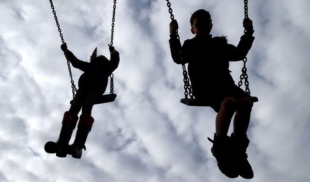 Children enjoy playing on swings (Gareth Fuller/PA)