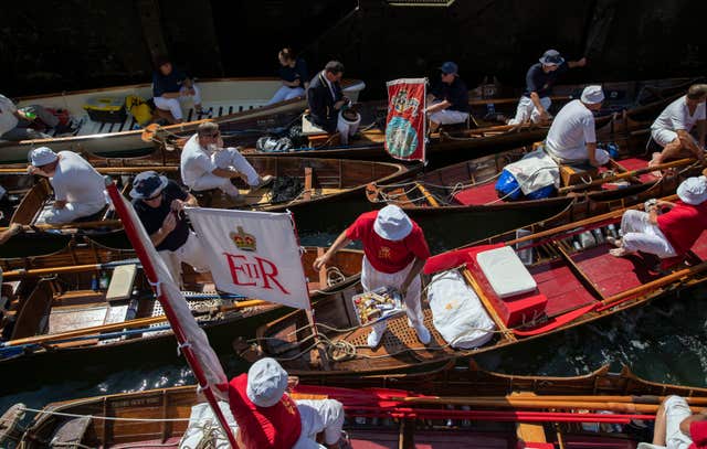 The Queen’s Swan Uppers negotiate a lock at Shepperton, Surrey, during the census (Steve Parsons/PA)