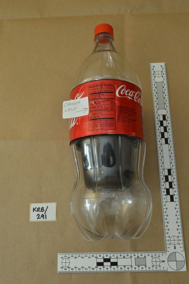 A Coca-Cola bottle adapted with a camera lens to be used for spying