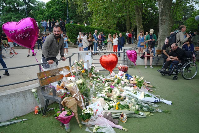 Tributes left near the scene at a lakeside park in Annecy, France 