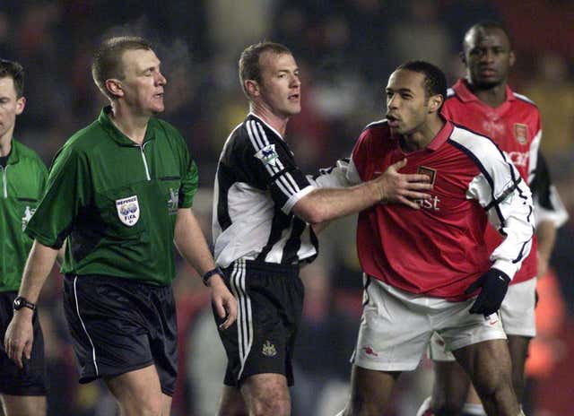 Arsenal’s Thierry Henry is held back by Newcastle’s Alan Shearer as he tries to reach match referee Graham Poll