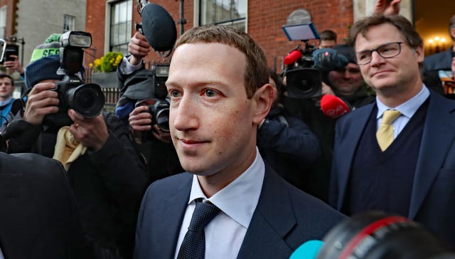 Facebook CEO Mark Zuckerberg leaving The Merrion Hotel in Dublin with Sir Nick Clegg behind him