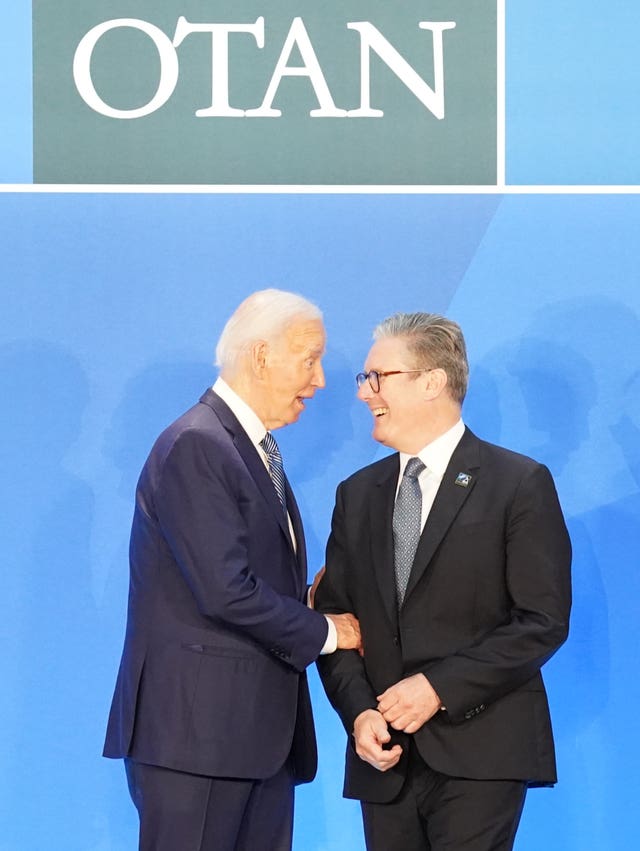 Prime Minister Sir Keir Starmer smiles with US President Joe Biden at the Nato summit in Washington