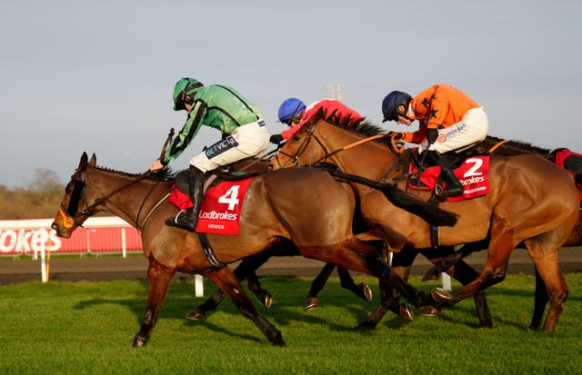 Hewick (left) on his way to winning the King George at Kempton Park