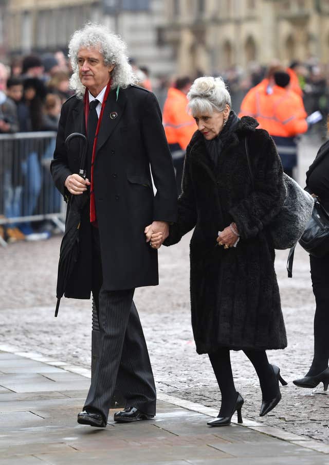 Brian May and Anita Dobson arrive for the funeral service of Professor Stephen Hawking at University Church of St Mary the Great in Cambridge (Joe Giddens/PA)
