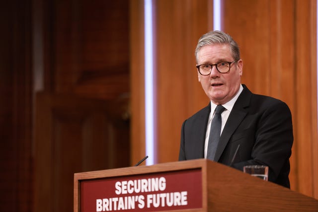 Sir Keir Starmer speaking from a podium which reads 'Securing Britain's future'