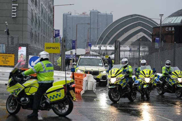 A convoy of police motorcyclists leave by a security gate at the Scottish Event Campus in Glasgow where Cop26 is being held (Andrew Milligan/PA)