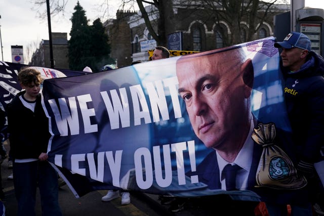 Tottenham fans hold a banner reading 'We want Levy out' featuring a picture of chairman Daniel Levy