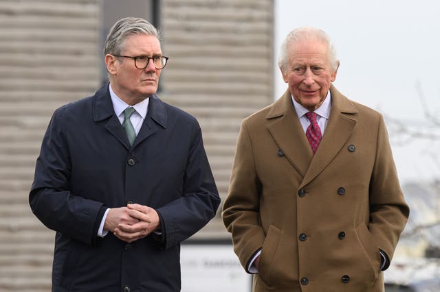 Sir Keir Starmer and the King walk side by side 