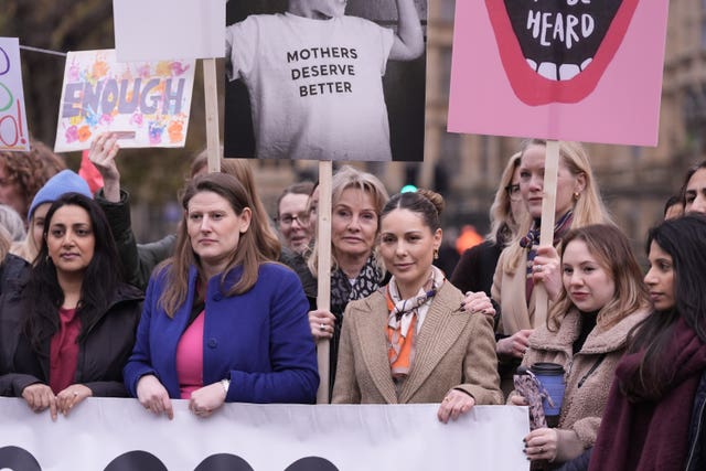 Conservative MP Theo Clarke (centre left) and Louise Thompson (centre right) standing with other women holding placards