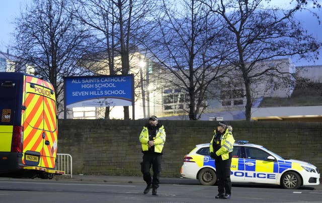 Two police officers stand outside the school