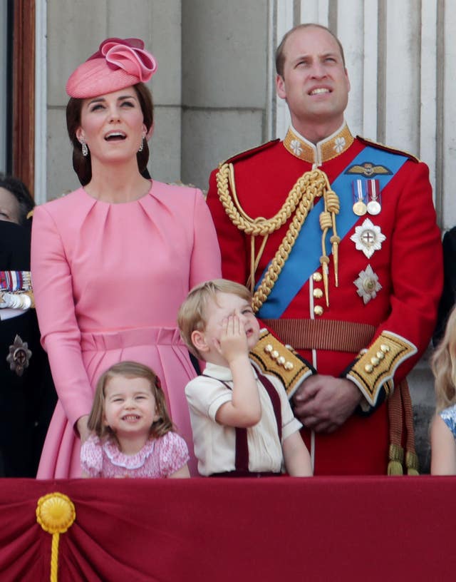 Charlotte and her family watching the flypast (Yui Mok/PA)