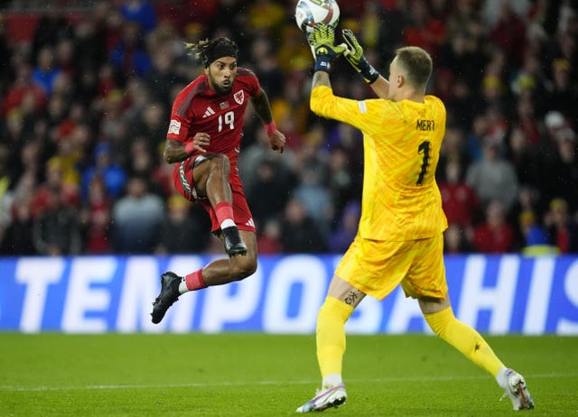 Wales' Sorba Thomas, left, leaps to finish past Turkey goalkeeper Mert Gunok before being flagged offside