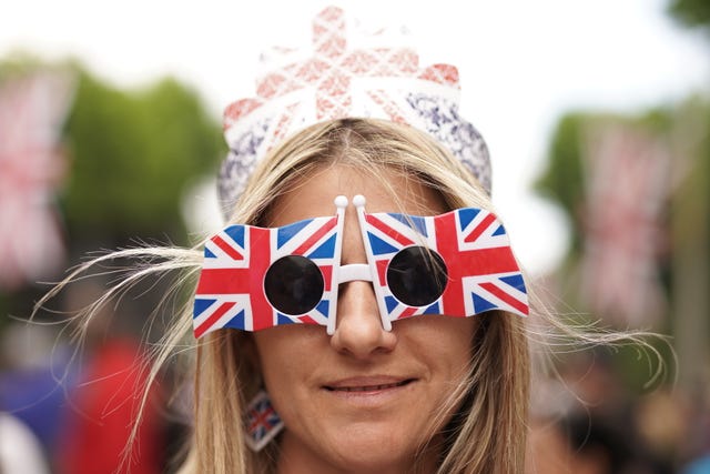 A member of the public wearing Union Jack glasses on the Mall before the Platinum Party at the Palace