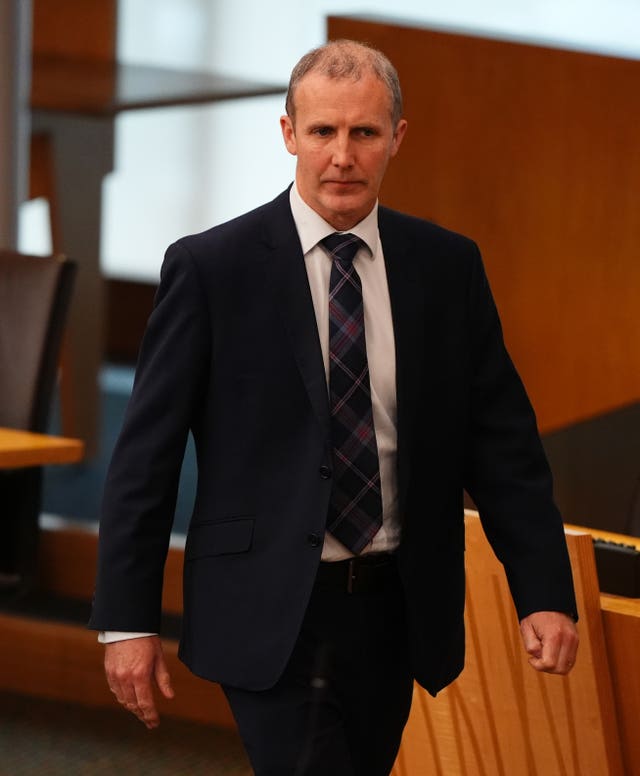 Michael Matheson walks through the Scottish Parliament chamber