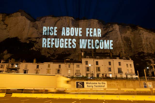 The White Cliffs of Dover lit up with a series of projections in support of migrant welfare 