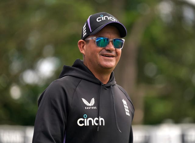 Former England white-ball coach Mathew Mott looks on at training in sunglasses.