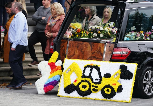 Floral tributes are left by the hearse as the funeral Mass for Mikey and Thelma Dennany takes place in Longford