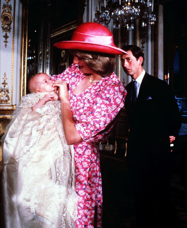 The Prince and Princess of Wales at Buckingham Palace with their son Prince William on the day of his christening 
