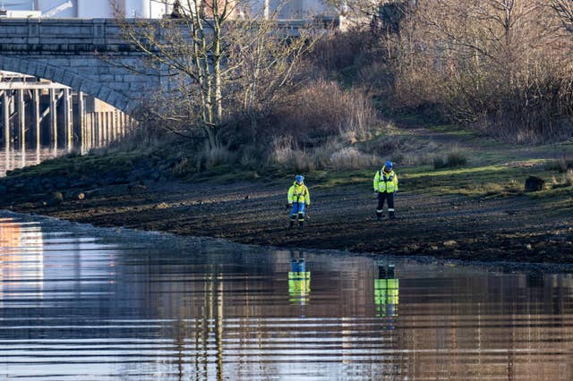 Police searching next to the River Dee