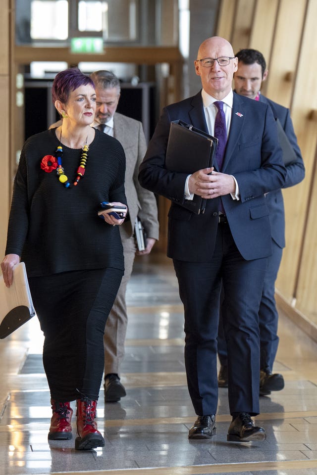 John Swinney walking alongside Angela Constance in Holyrood