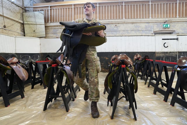 A member of the Blues and Royals with horse tack before a first ride-out ahead of rehearsals for the US state visit 