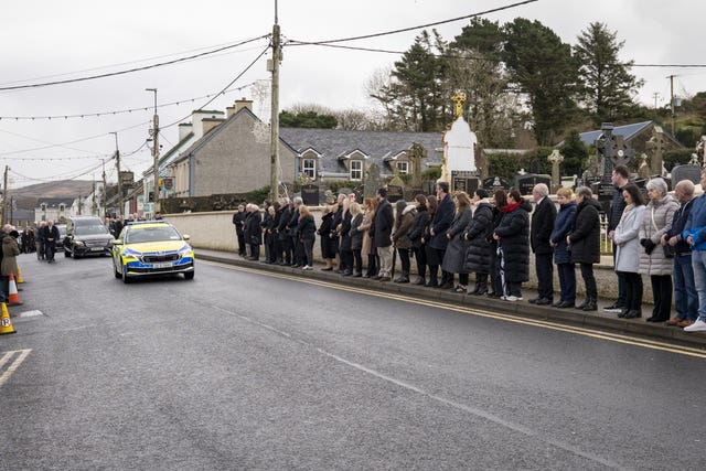 Mourners outside the Church Of The Holy Family in Ardara