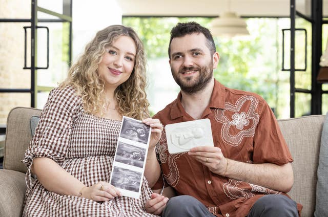 Sophy and Reece Finnegan-Knight holding a tactile sonogram