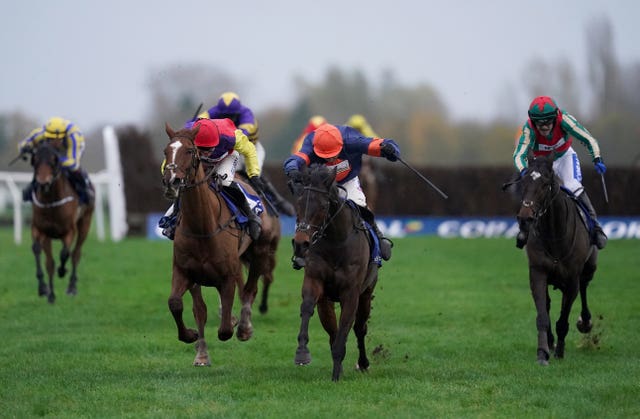 Le Milos and jockey Harry Skelton (centre) coming home to win the Coral Gold Cup at Newbury