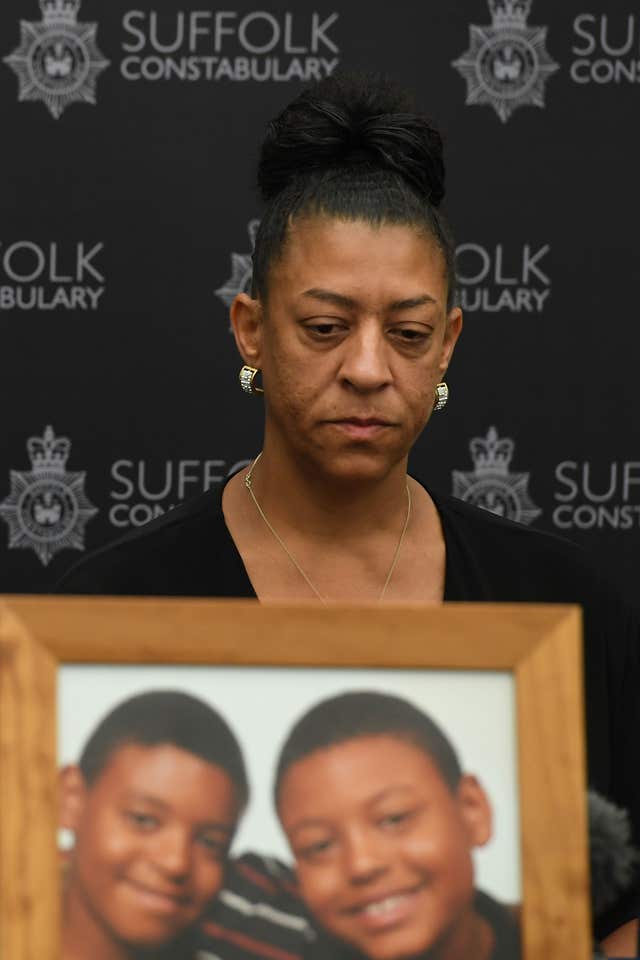 Tavis Spencer-Aitkens’ mother Sharon Box sits behind a photo of the 17-year old (right) and his twin brother Tyler 