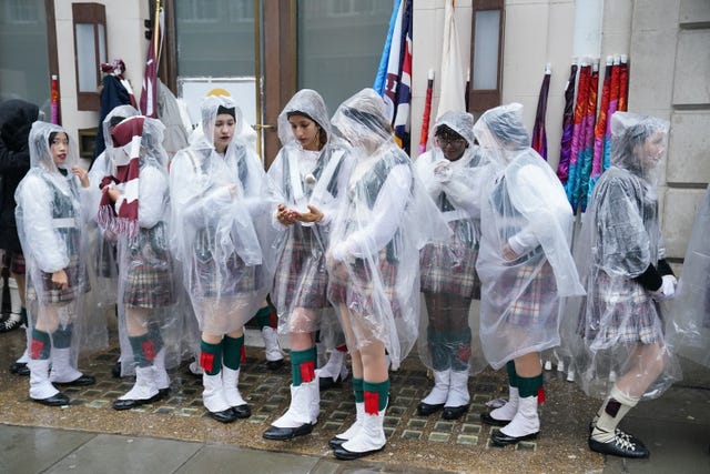 Rain falls as marching band members from Riverview High School in Florida prepare to take part in the New Year’s Day Parade in central London. 