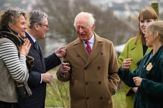 Charles chuckles as he speaks with the PM and the Deputy Prime Minister during the visit to Cornwall on Monday 