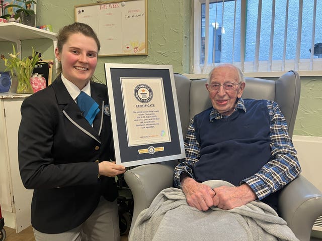 John Tinniswood being presented with his Guinness World Record certificate