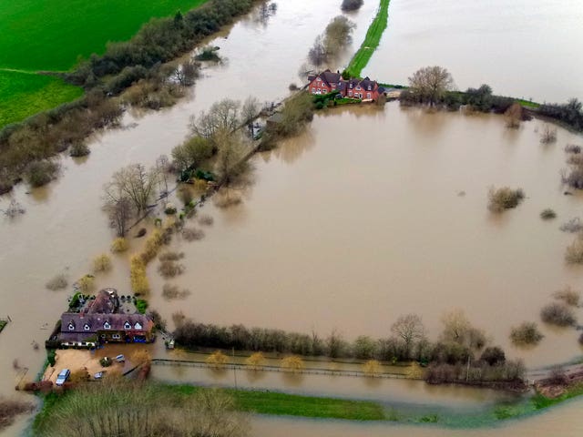 Flood water has surrounded houses in Uckinghall (Steve Parsons/PA).