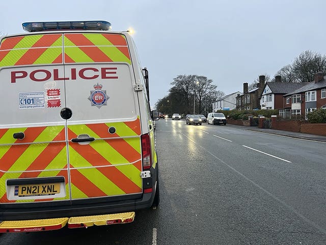 Police near to the scene where a Seat Leon collided with a Citroen C4 Picasso taxi on Wigan Road in Bolton