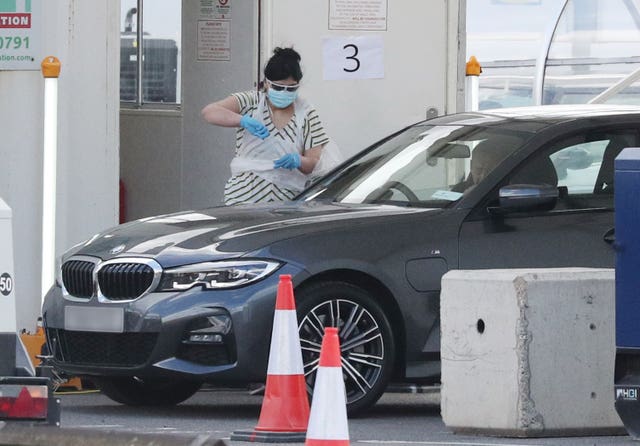 A person holds a swab at a Covid-19 drive-through test centre for NHS workers