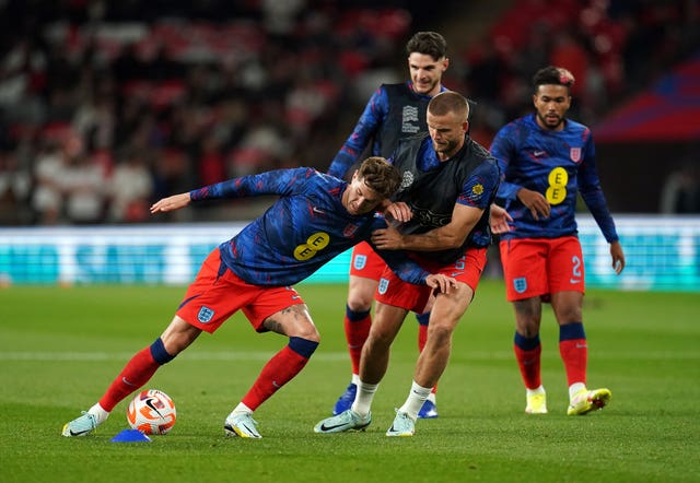 Eric Dier (centre) and John Stones (left) warm up