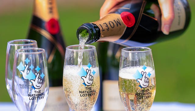 A bottle of Moet & Chandon champagne with The National Lottery branded champagne flutes (Peter Byrne / PA)